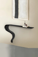 Modern black wall shelf against a neutral wall with a framed abstract painting, Obroi