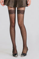 Obroi Person wearing sheer black tights with dot pattern and a brown skirt on a light gray background