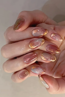 Close-up of hands with pink and gold nail polish on a neutral background, Obroi