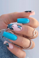 Obroi Nails with blue and pink design featuring butterflies, held by a person.