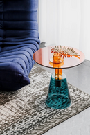 Small round table with a glass top and textured base in a room setting, Obroi