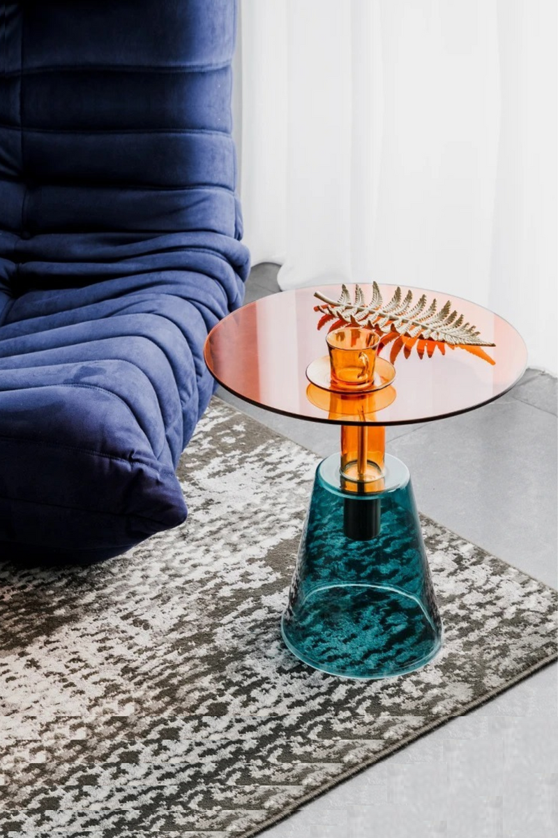 Small round table with a glass top and textured base in a room setting, Obroi