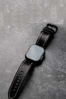 Obroi Smartwatch with a black leather strap on a gray surface