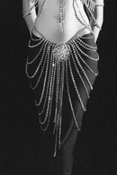 Elegant outfit with a detailed, beaded backpiece on a black background, Obroi