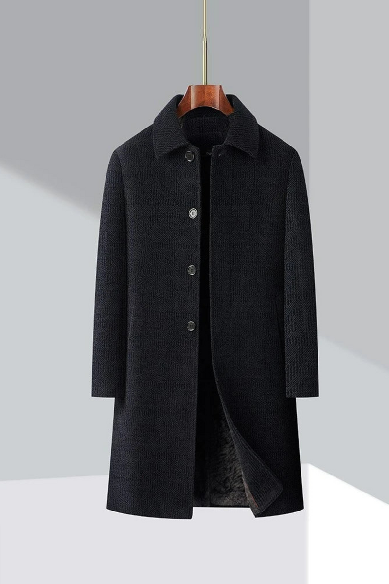Black coat on a hanger against a gray background, Obroi