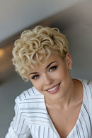 Woman with styled blonde hair wearing a white top indoors, Obroi