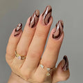 Hand with glittery brown nail polish on a gray background, Obroi