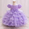 Lavender dress with ruffles and a bow on a mannequin against a white background, Obroi