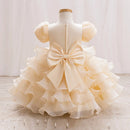 Cream-colored dress with a large bow on a mannequin against a white background, Obroi