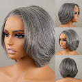 A layered bob wig in a salt and pepper gray color, shown on a mannequin head from multiple angles including a large side profile, a three-quarter face view, a three-quarter back view, and a rear view. An orange text banner at the bottom reads 'Pre-Sale Salt and Pepper Layered Bob Wig', Obroi