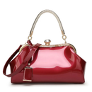 Red handbag with gold accents on a white background, Obroi