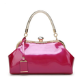 Pink handbag with gold accents on a white background, Obroi