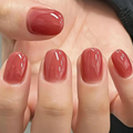 Close-up of a hand with red nail polish on a neutral background, Obroi