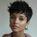 Woman with short, curly black hair wearing earrings against a neutral background, Obroi