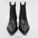 Pair of black cowboy boots on a light gray background, Obroi