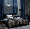 Luxurious bedroom with a large bed, decorative pillows, and a stylish wall lamp, Obroi