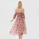 Woman wearing a floral off-shoulder dress on a white background, Obroi