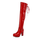 Red patent leather knee-high boot on a white background, Obroi