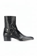 Black crocodile-embossed leather ankle boots with a side buckle strap, shown in a side profile on a white background with the Obroi brand name in the top left corner, Obroi