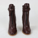 Pair of brown leather boots with zippers on a white background, branded 'Obroi'.