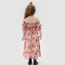 Child wearing a floral off-shoulder dress on a white background, Obroi
