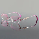 Pink and silver eyeglasses with 'Obroi' branding on a gray background