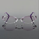 Pair of rimless eyeglasses with purple arms on a gray background, featuring the Obroi brand.