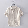 Beige linen shirt on a hanger against a gray background, Obroi