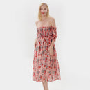 Woman wearing a floral strapless dress on a white background, Obroi