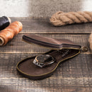 Brown leather case with a watch on a wooden surface, Obroi