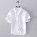 White short-sleeve shirt on a hanger against a gray background, Obroi