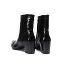 Black patent leather ankle boots with block heels on a white background, featuring the brand 'Obroi'.