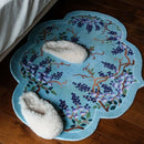 Decorative rug with floral design on a wooden floor, Obroi