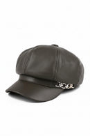 Dark gray leather cap with a decorative emblem on a white background, Obroi