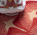 Close-up of a red and white patterned fabric with a cartoonish face design, Obroi