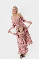 Two women wearing matching floral dresses on a white background, Obroi