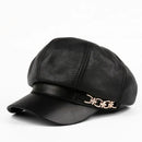 Black leather cap with a decorative gold emblem on a white background, Obroi