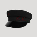 Black cap with red embroidery on a light gray background, Obroi