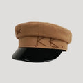 Brown cap with black visor on a light gray background, Obroi