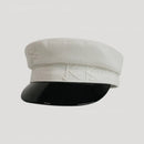 White cap with black visor on a light gray background, Obroi