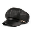Black leather cap with a gold chain on a white background, Obroi