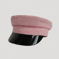 Pink cap with black visor on a light gray background, Obroi
