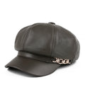 Dark gray leather cap with gold emblem on a white background, Obroi