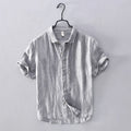 Striped shirt on a hanger against a plain background, Obroi