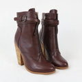 Brown ankle boots with wooden heel on a white background, branded 'Obroi'.