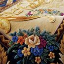 Close-up of an embroidered floral design on a fabric with gold and blue accents, Obroi