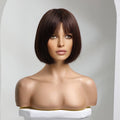 A dark brown bob wig with straight bangs displayed on a mannequin bust against a light gray studio background, Obroi