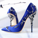 Blue high-heeled shoes with silver leaf designs on a white background, Obroi