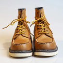 Pair of brown leather boots with yellow laces on a light background, Obroi