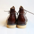 Pair of brown leather boots on a light background, Obroi